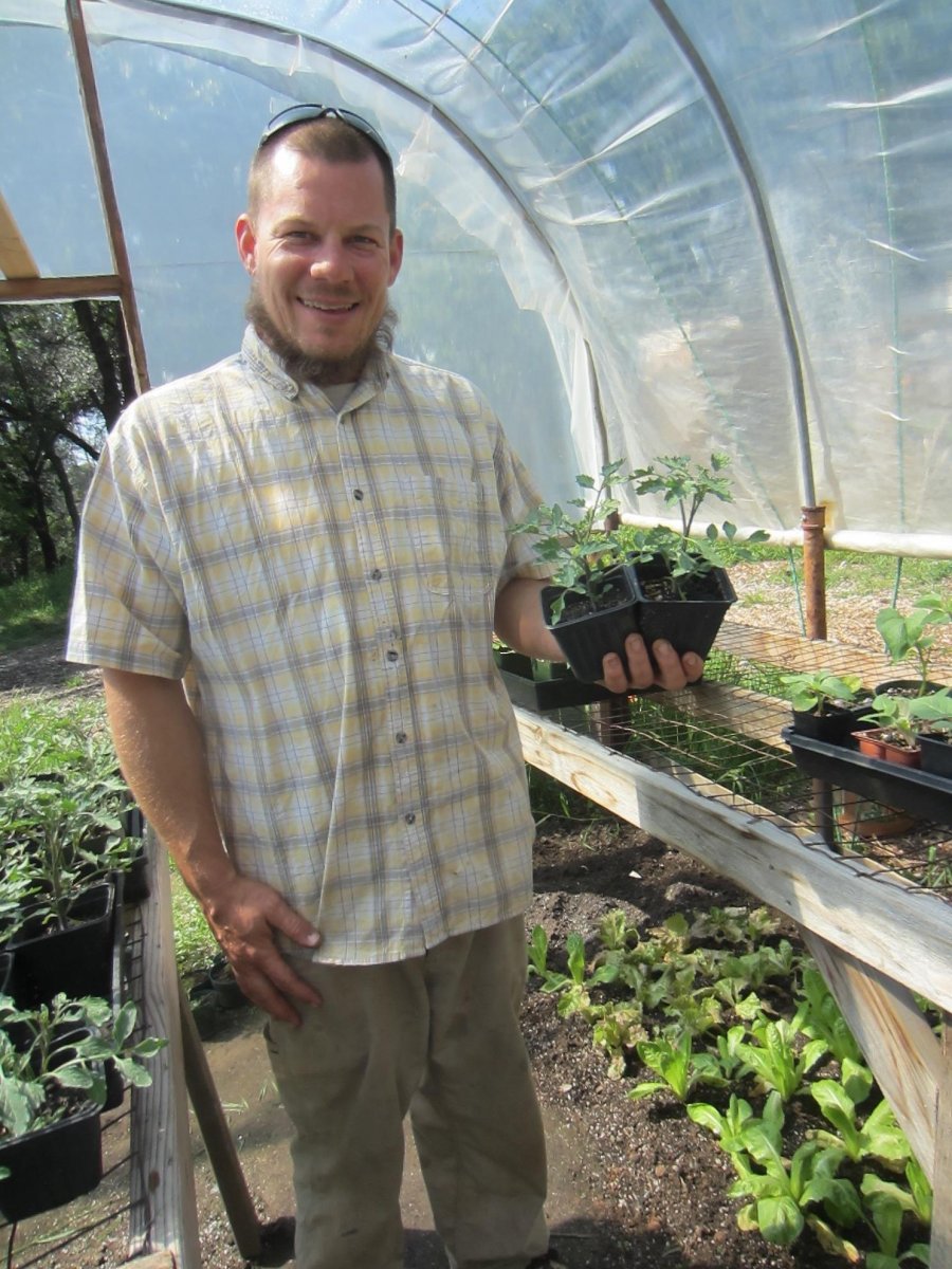 Greg holds two of his customers’ favorite sweet tomatoes: Sun Gold.